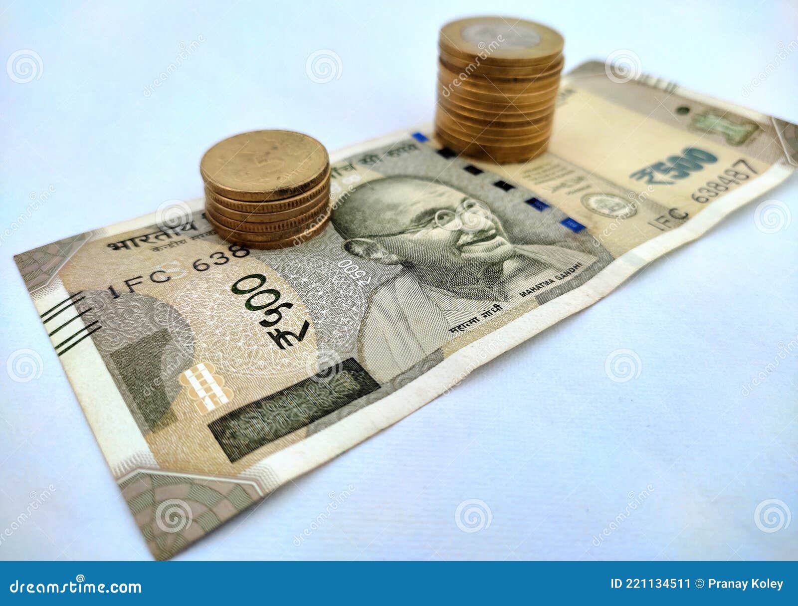 image of indian currency. indian rupees coins placed on500 rupees indian currencynotes.