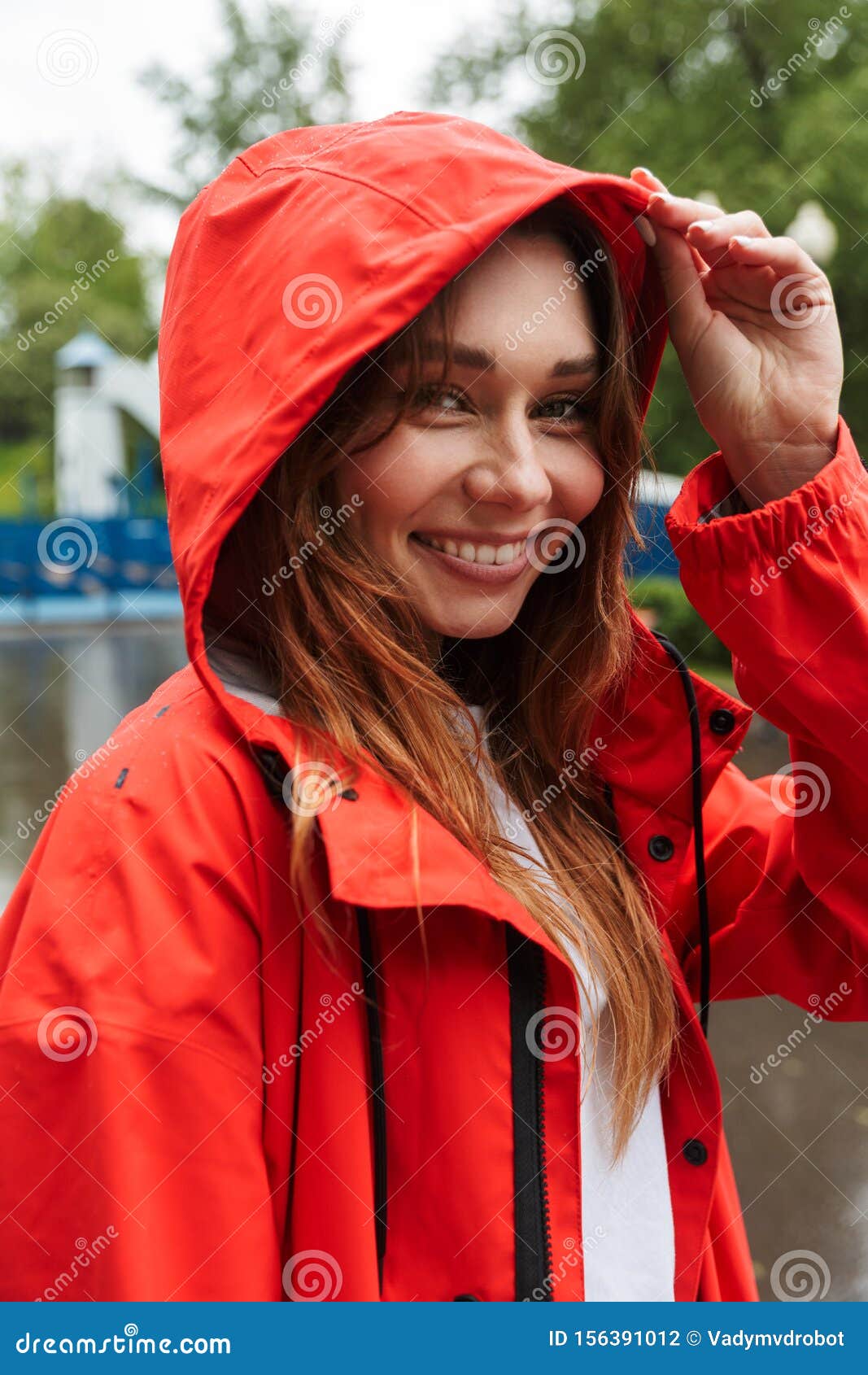 Image of Joyful Young Woman 20s in Colorful Raincoat Walking through ...