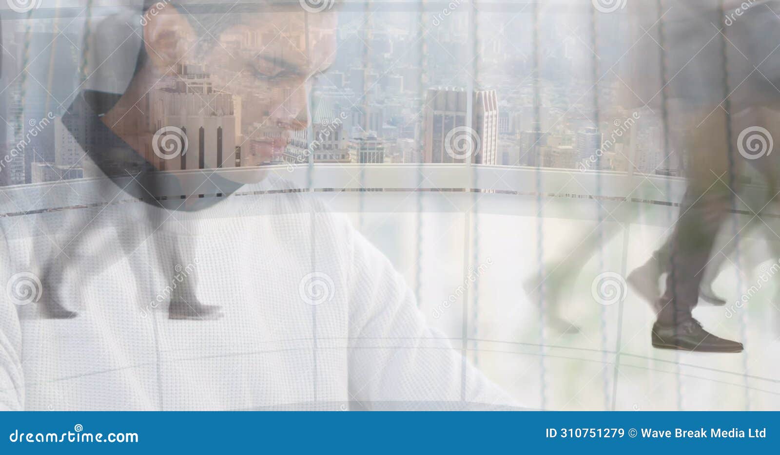 image of man working on laptop over sped up commuters walking in modern building