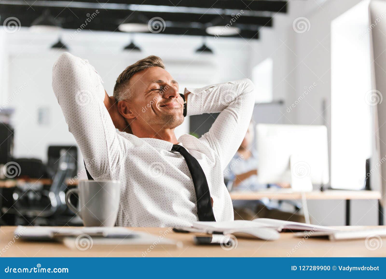 image of pleased middle aged business man relaxing