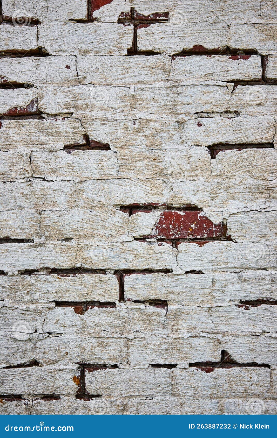 Red Brick Wall Painted White with Cracking Paint and One Exposed Red