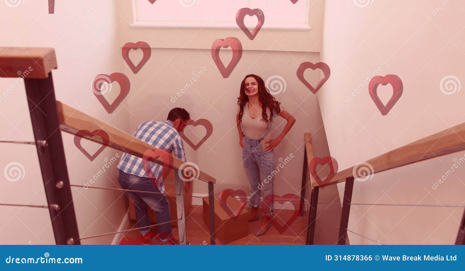 image of red hearts over couple with cardboard boxes in new home