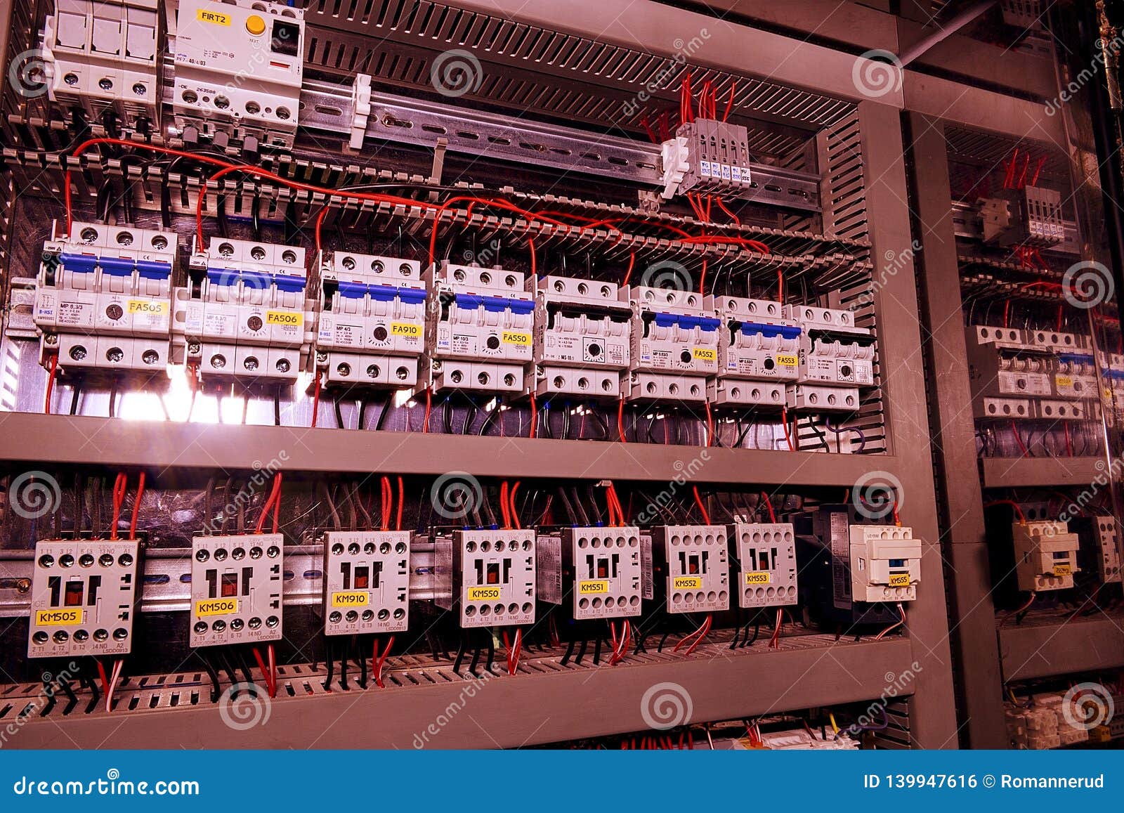 image shows circuit breakers and electrical contactors. close-up. modern distribution case. contorl cubicle. add brown