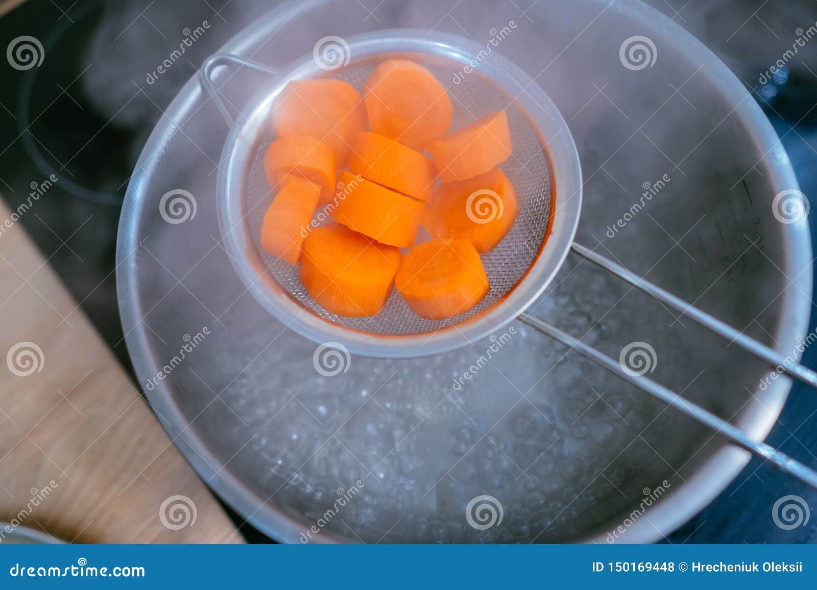 The Image of a Small Amount of Chopped Carrots Over a Boiling Pan Stock