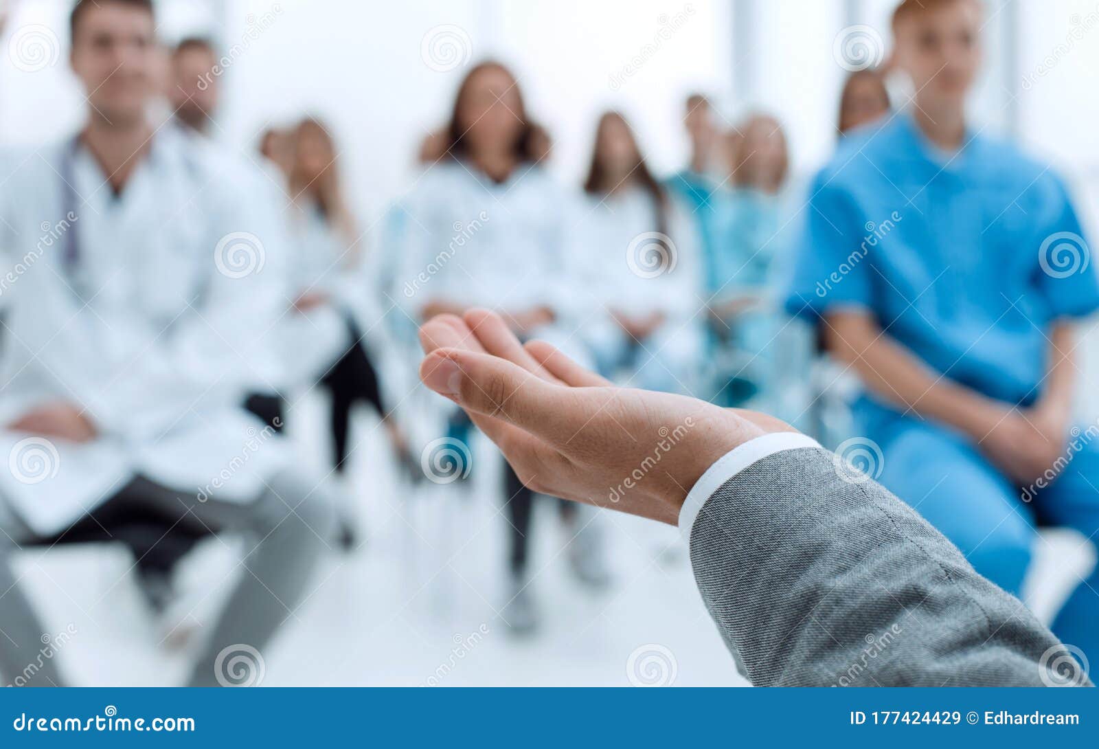 Image of a Speaker and a Group of Doctors in a Conference Room Stock
