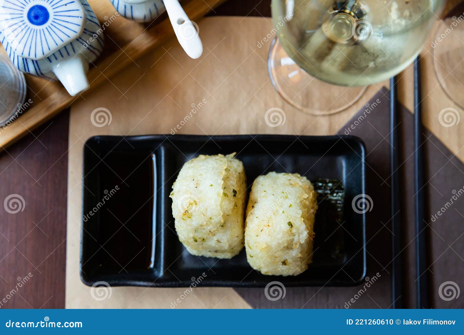 image of tasty triangular onigiri from rice at black plate