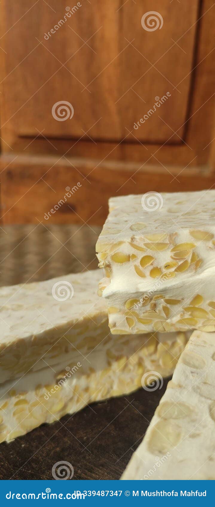 image of tempeh that hasn't yet fried white and photographed in the sun.
