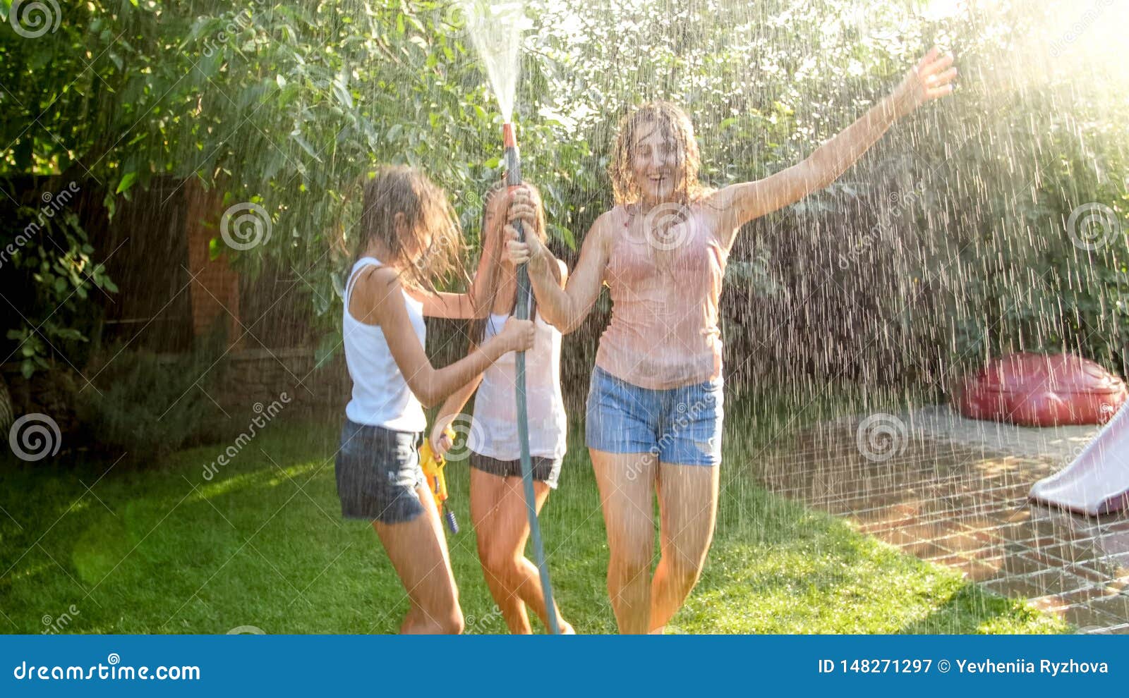 Photo Of Three Cheerful Teenage Girls Dancing In The Backyard Garden