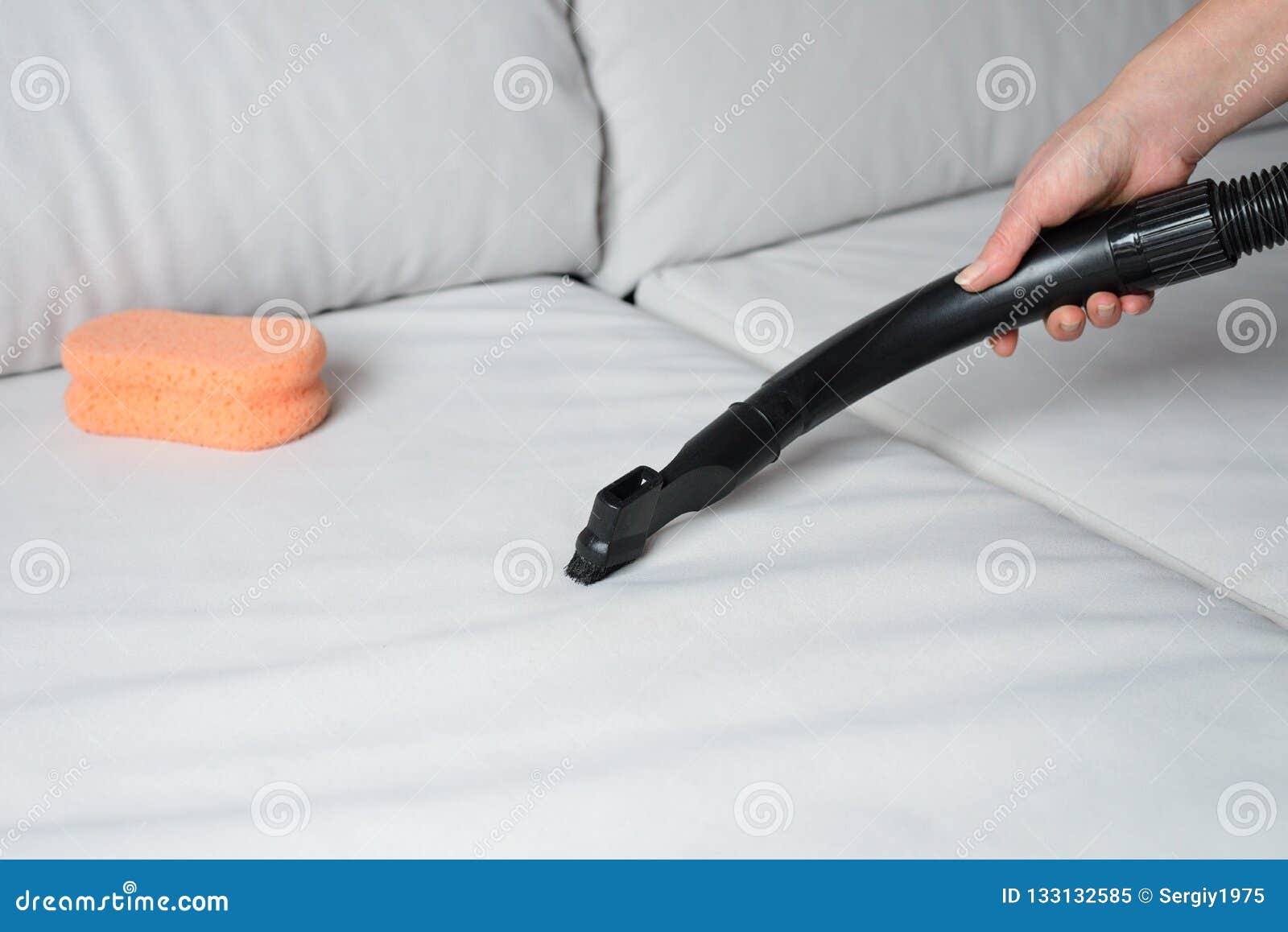 Vacuum cleaning the sofa stock image. Image of chemical 133132585