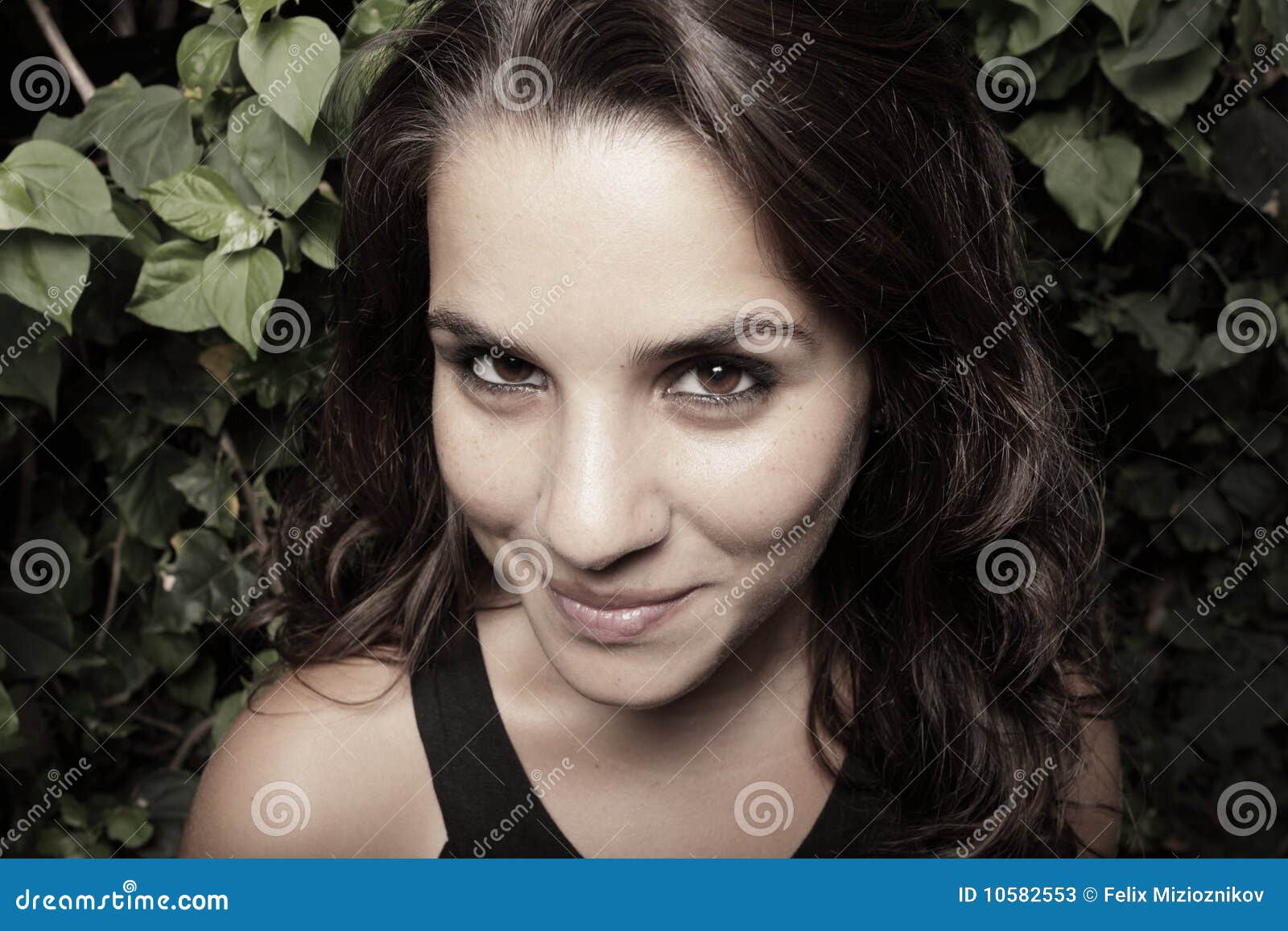 Image of a woman smiling. Headshot of a beautiful young woman smiling