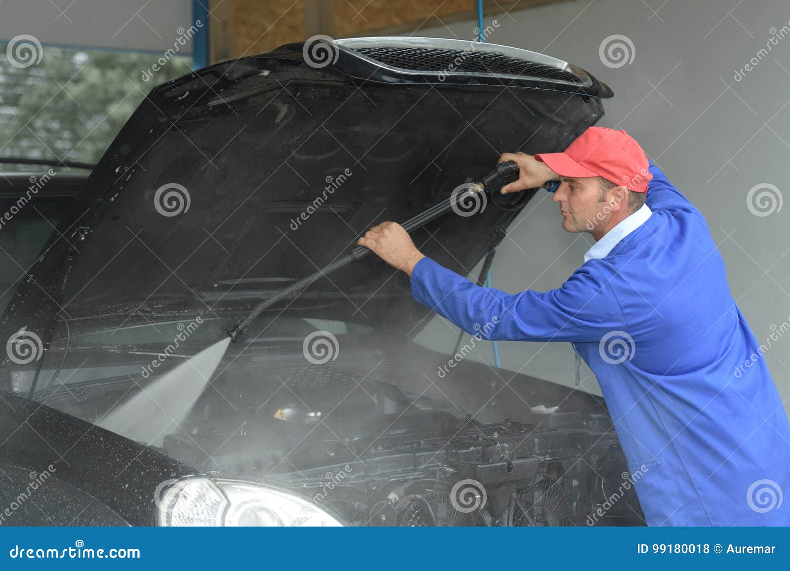 image worker cleaning cars engine with karcher