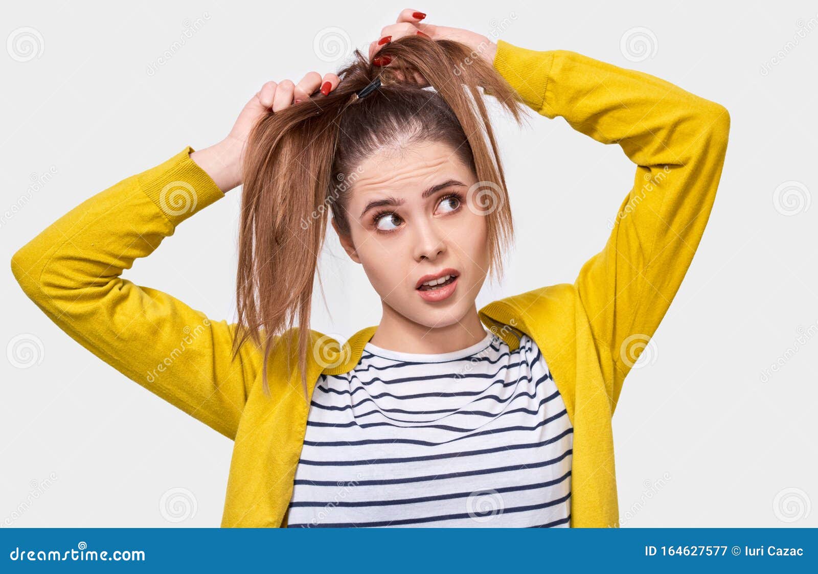 Image of Young Woman Collecting Hair in a Ponytail, Wearing Casual Outfit, Posing Over White Studio Wall. Female Makes Ponytail, Stock Image - Image of expression, health: 164627577 Image of Young Woman Collecting Hair in a Ponytail, Wearing Casual Outfit, Posing Over White Studio Wall. Female Makes Ponytail, Stock Image - Image of expression, health: 164627577