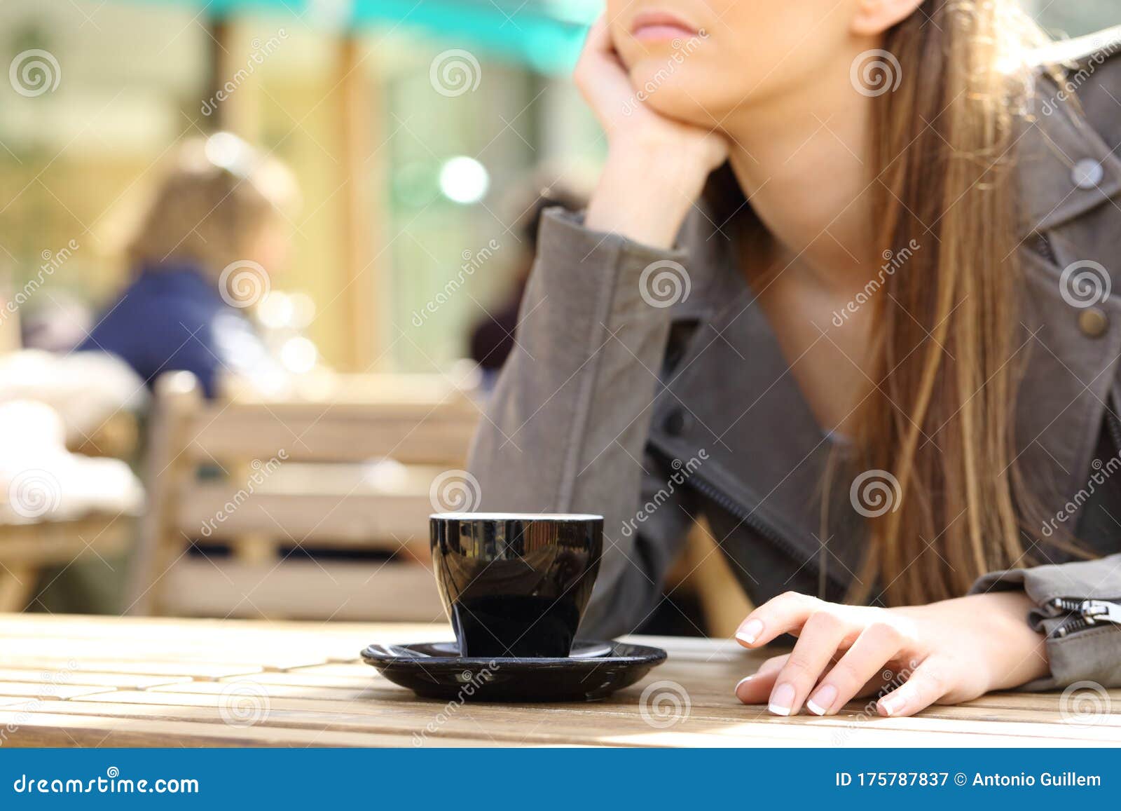 impatient woman waiting on a cafe terrace