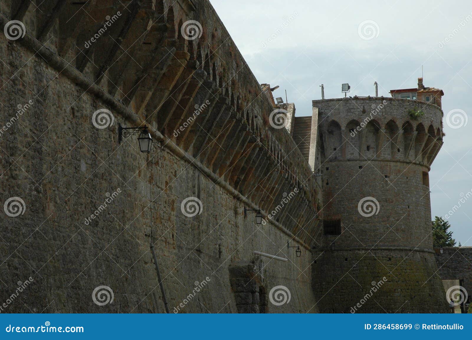 view of the walls and one of the towers of the medici fortress in volterra