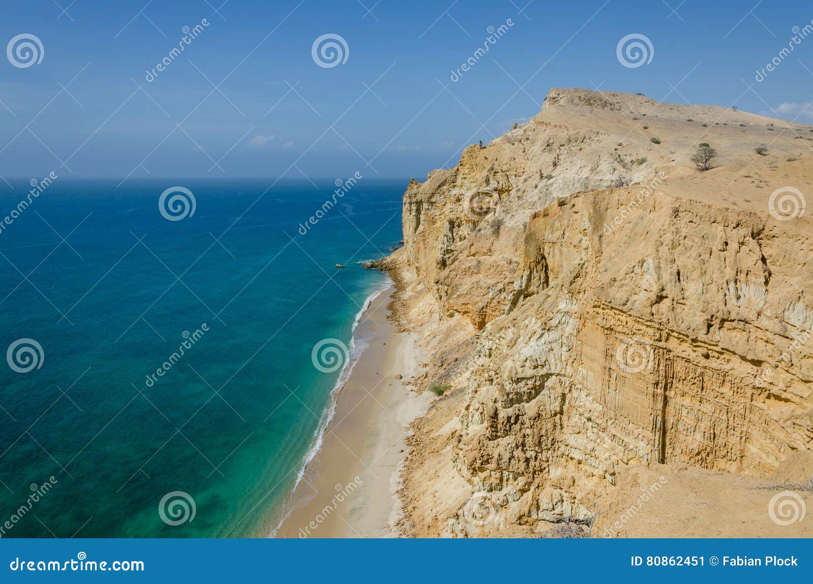 impressive cliffs with turquoise ocean at the coast at caotinha, angola