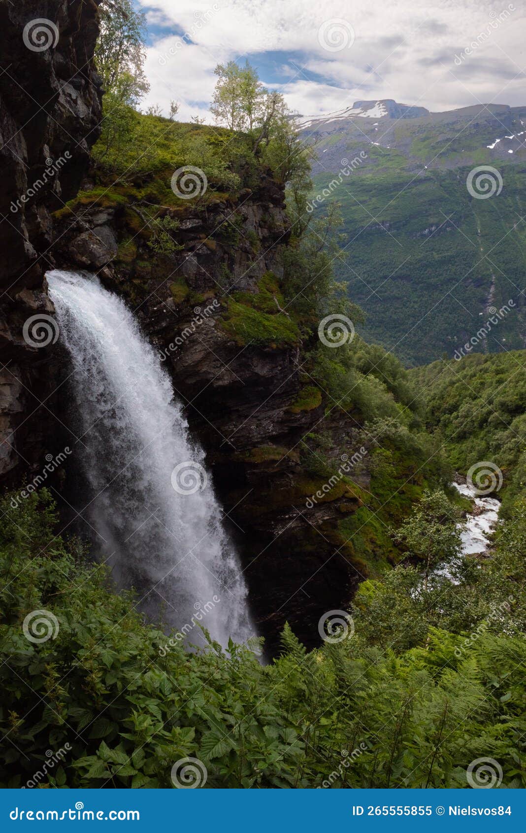 the impressive storseterfossen storsÃÂ¦terfossen with a path leading behind it throwing water down towards geiranger