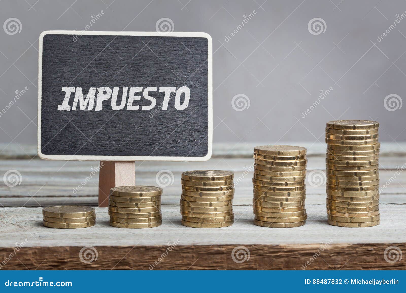 impuesto, spanish text for tax on board, growing stacks of money