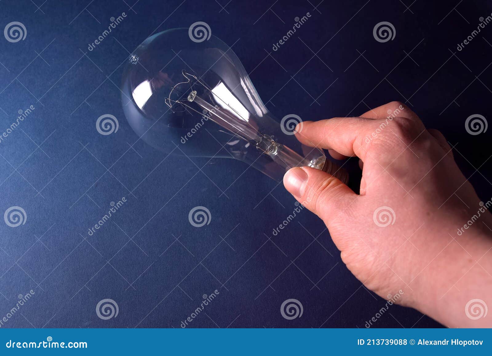 Incandescent Lamp in the Hand. Stock Photo Image of blue, gadget