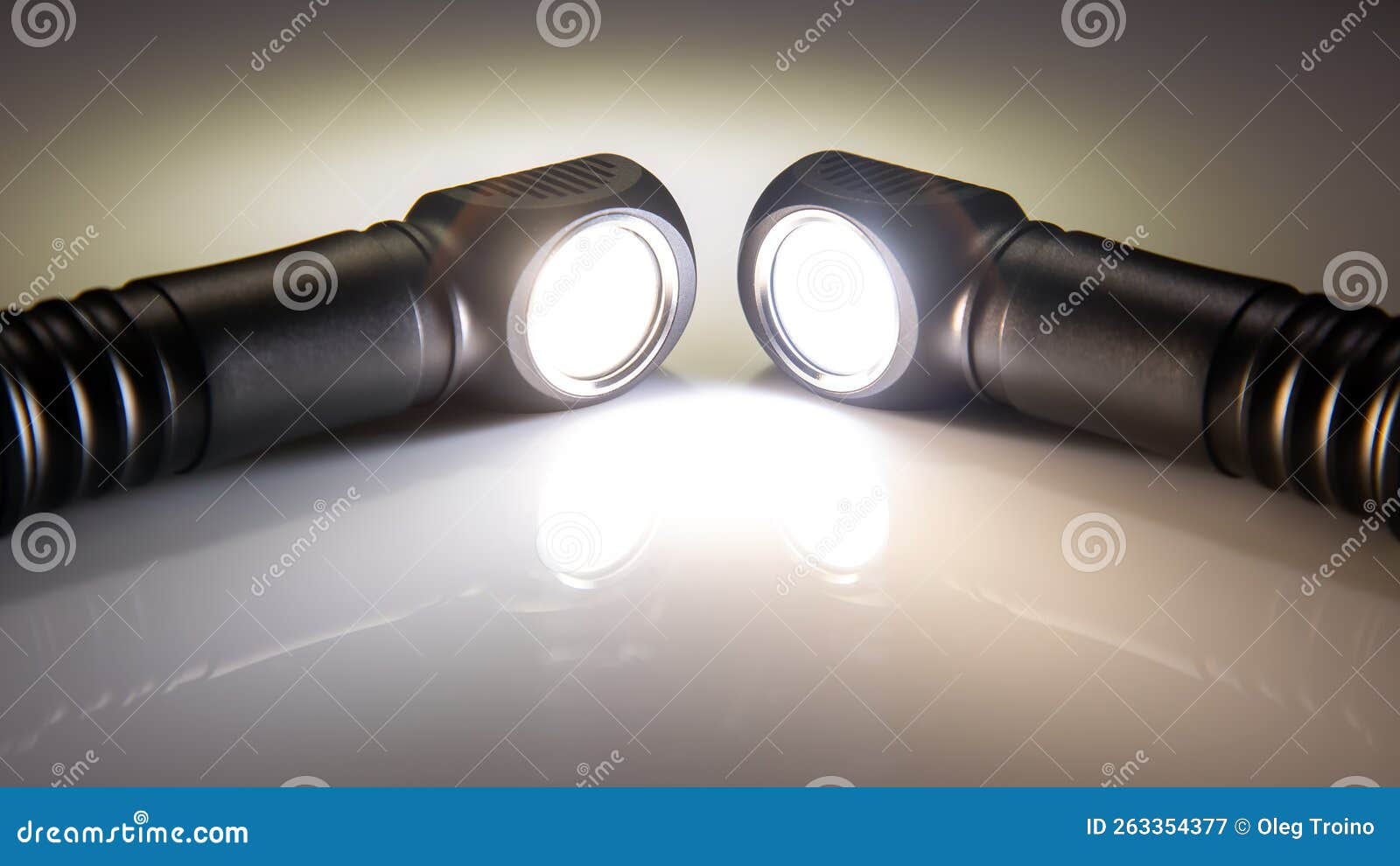 Included Light Beams of Different Flashlights on a Dark Background