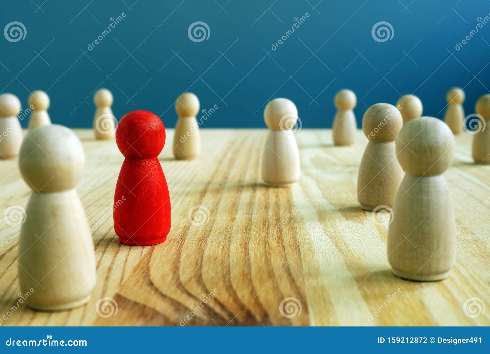 inclusion social concept. red figurine between wooden figurines