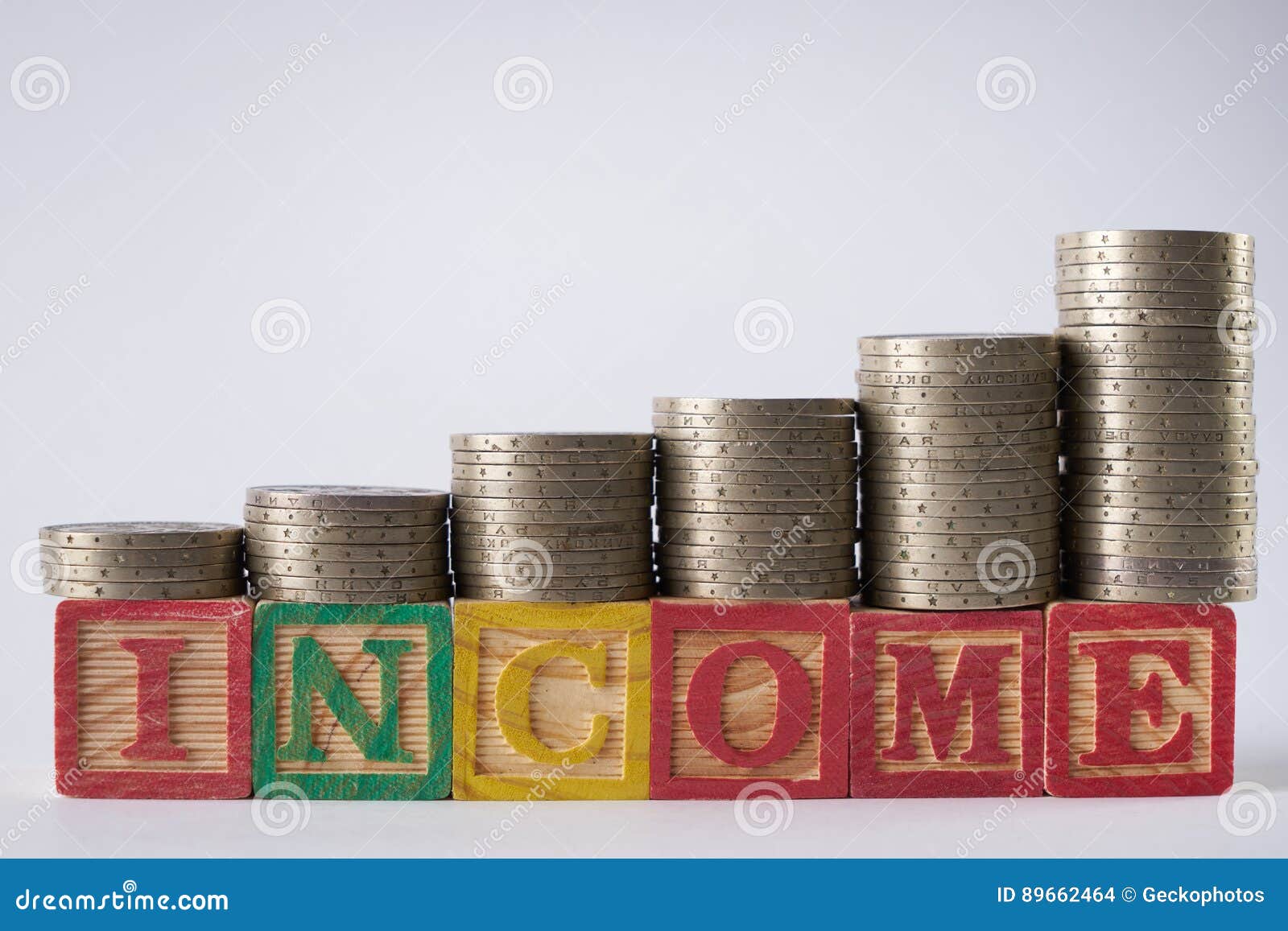 INCOME Text Written On Wooden Blocks With Stacked Silver ...