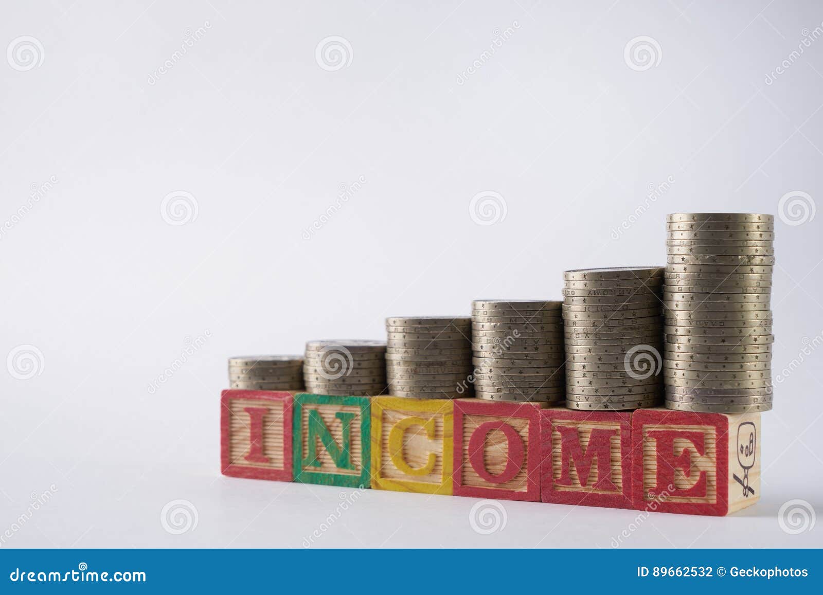 INCOME Text Written On Wooden Blocks With Stacked Silver ...