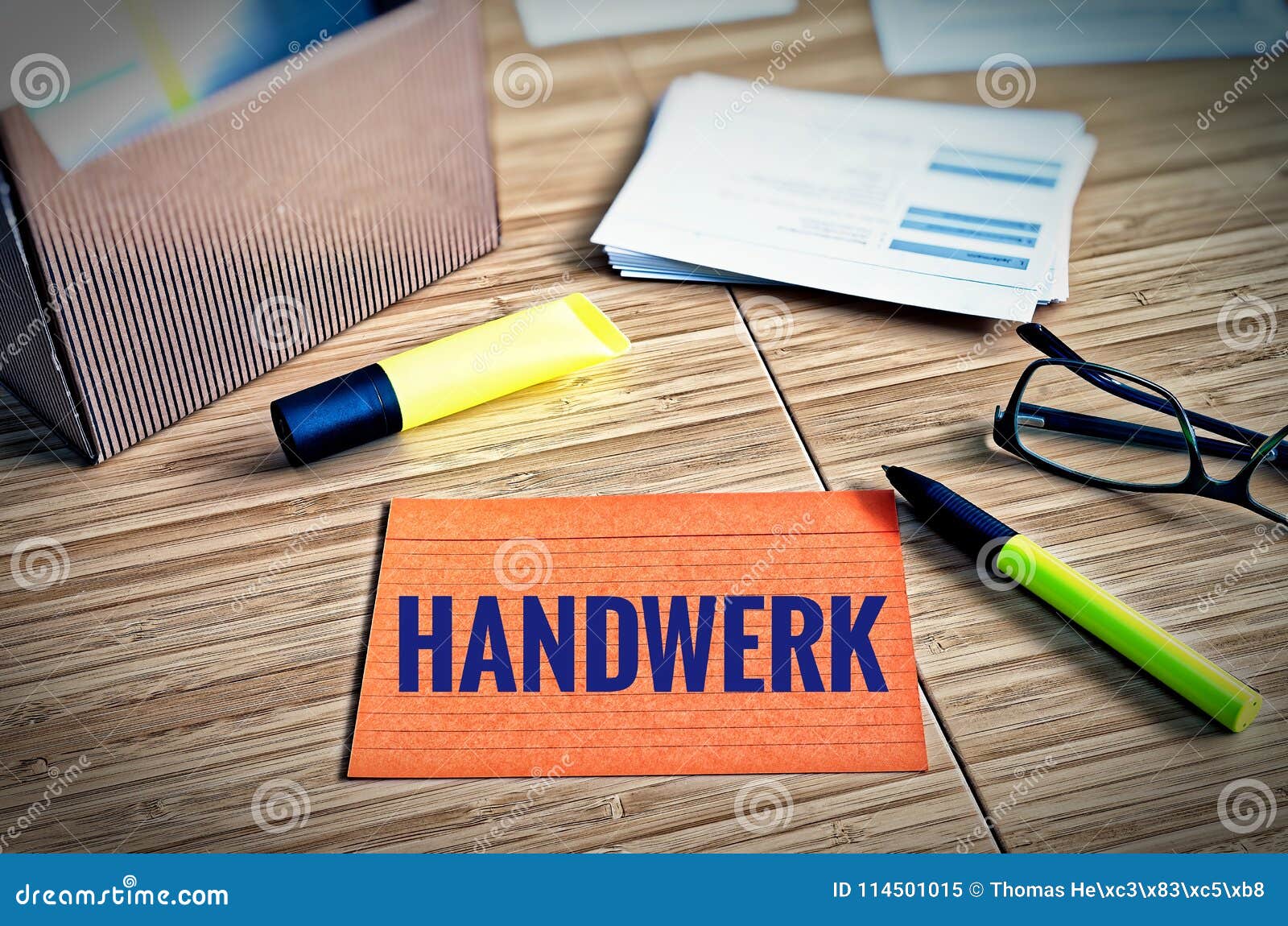 index cards with legal issues with glasses, pen and bamboo with the german word handwerk in english craft