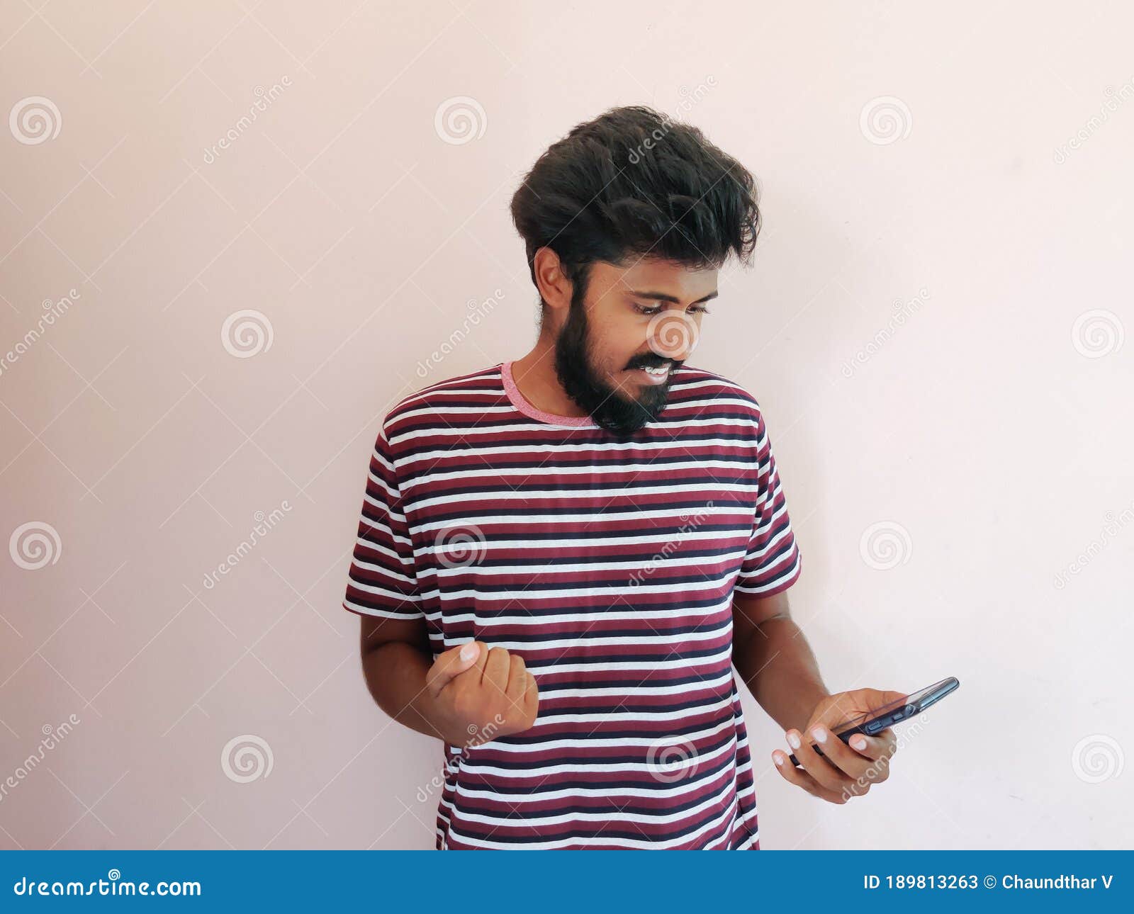 Indian Beard Man Looking at His Mobile Phone and Giving Reaction Stock ...