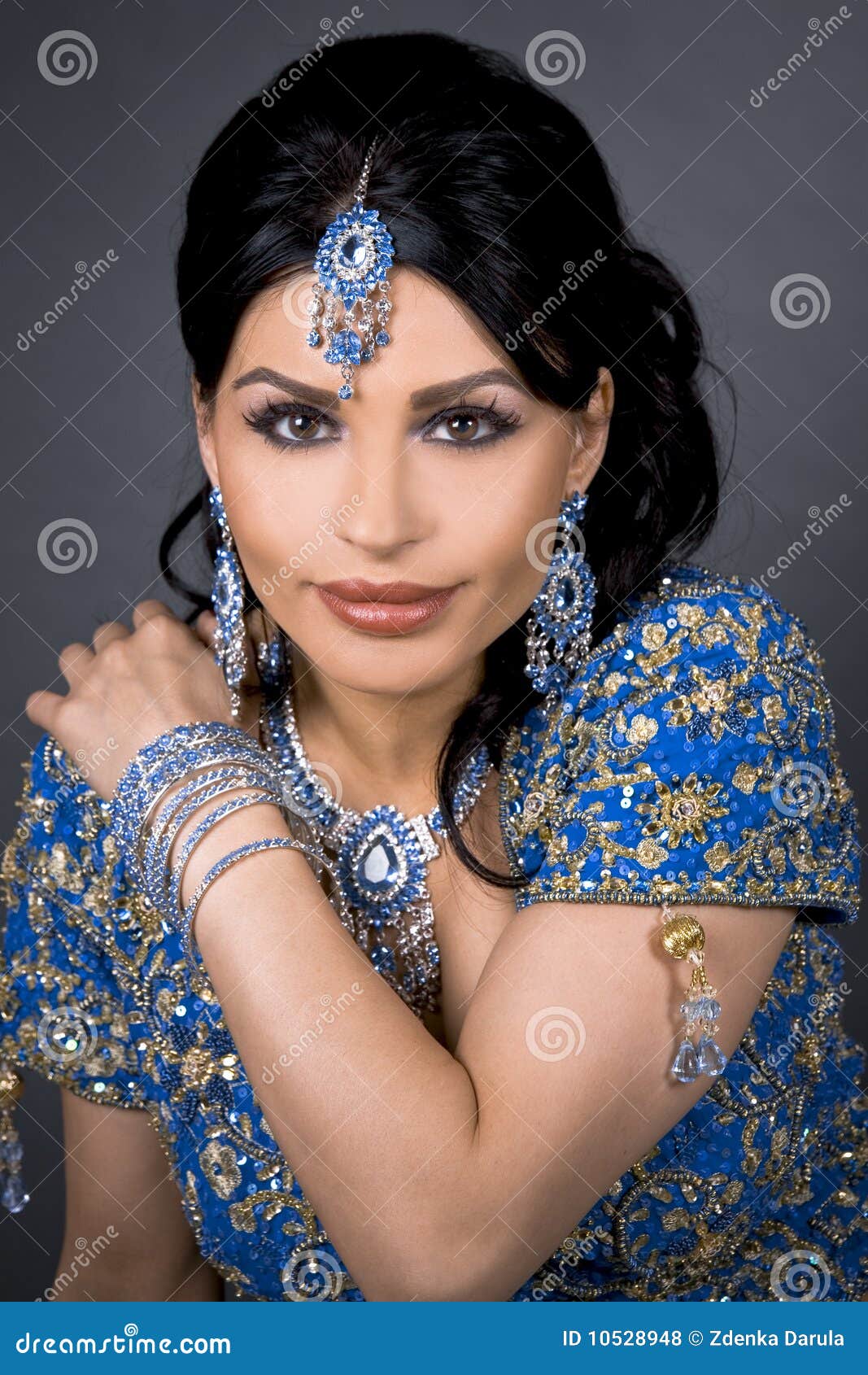 Indian bride. Pretty brunette wearing traditional indian outfit on dark