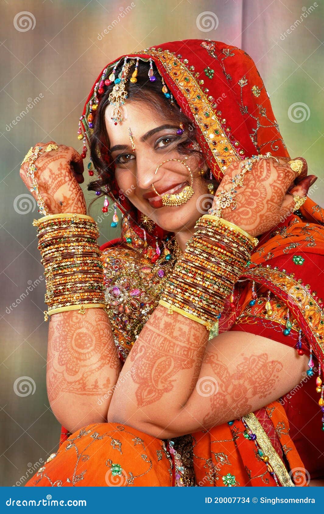 Portrait of a beautiful Indian bride in a traditional wedding dress. Young  Hindu woman with golden Kundan jewelry set. Traditional Indian costume  lehenga choli. kalira and red nail paint Stock Photo |