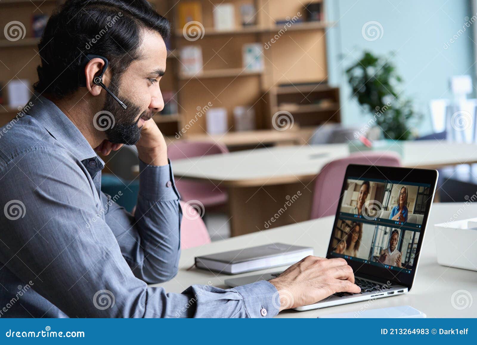 indian business man having virtual team meeting on video conference call.