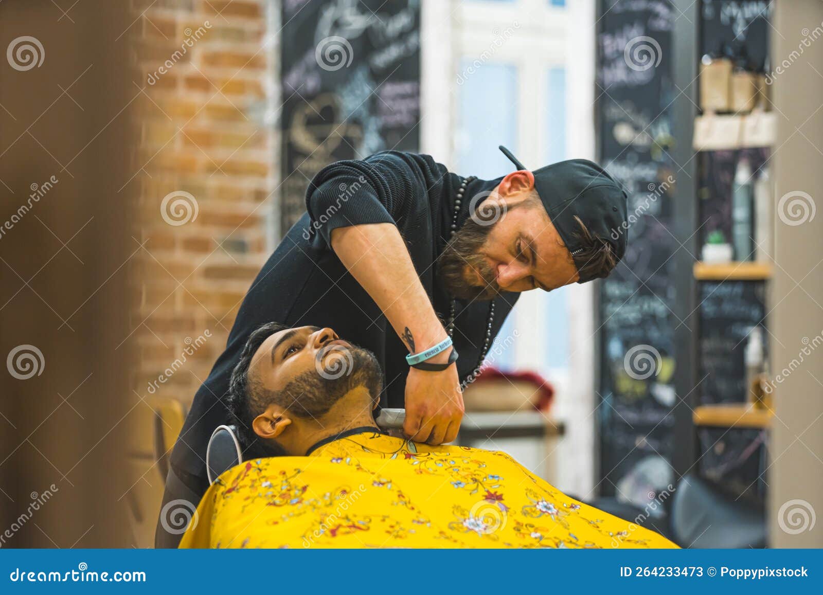 Indian Client Having His Beard Trimmed in the by, a