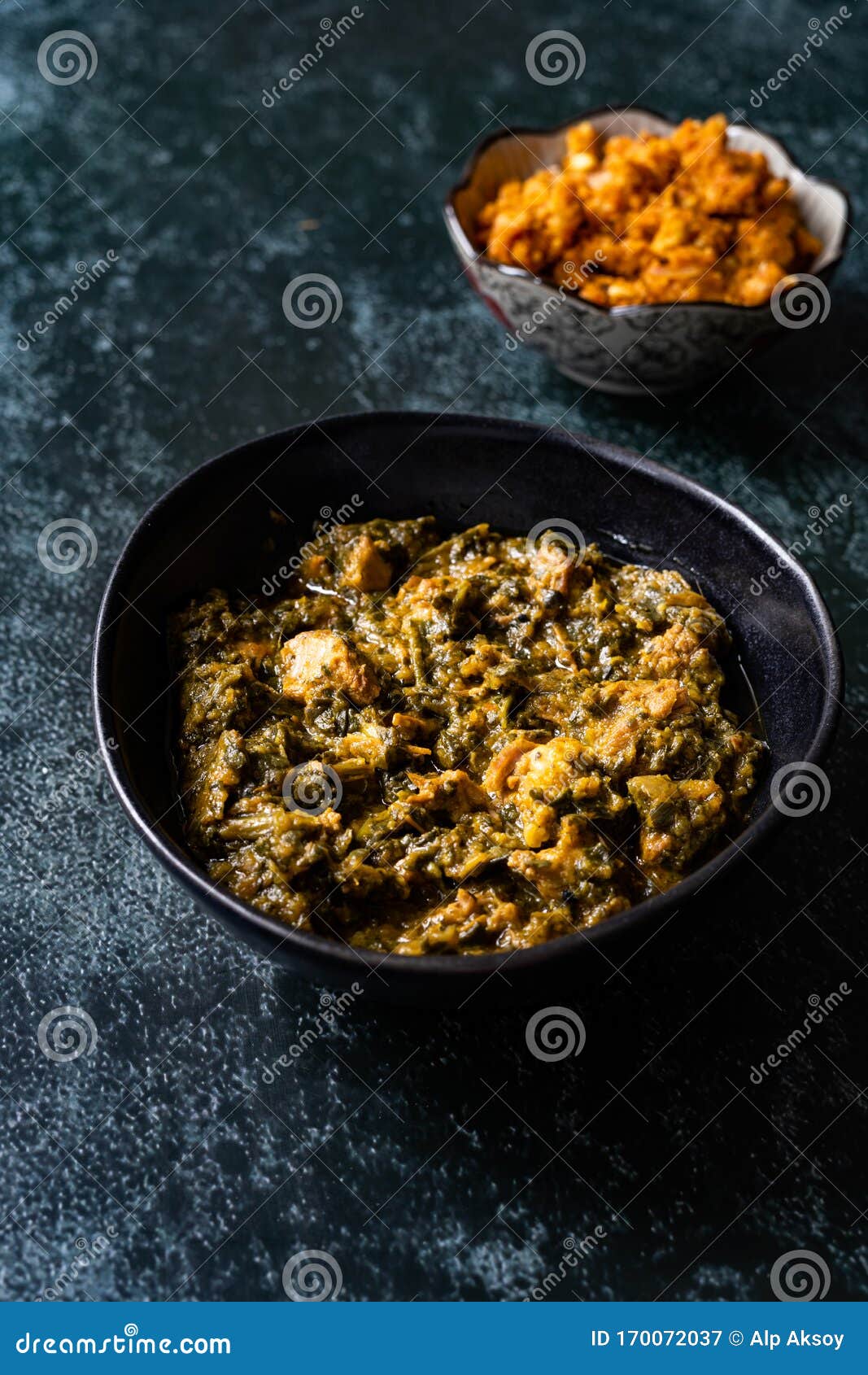 indian dish spinach lamb palak with gajar ka halwa / helva is a carrot-based sweet dessert pudding from india and flat bread