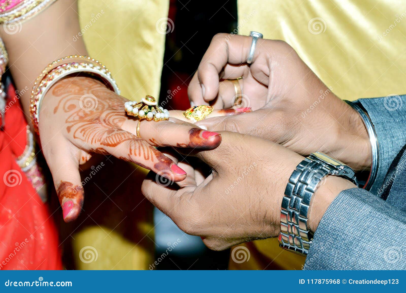 Indian Groom Putting Wedding Ring on Bride`s Hand Stock Photo Image