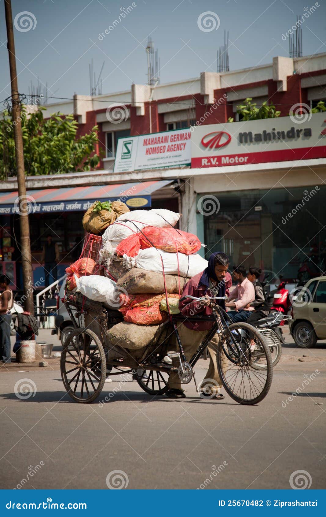 Indian Man Carrying Vegetable Sacks on Hand Cart Editorial Photography