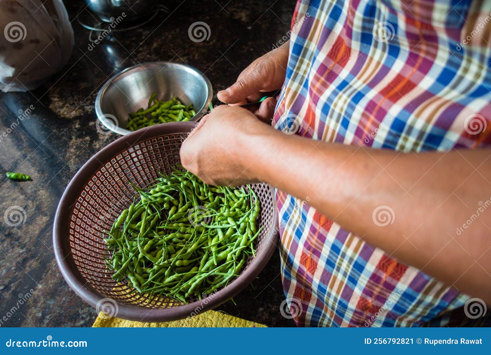 An Indian Man Processing Green Pigeon Pea Vegetable in the Kitchen