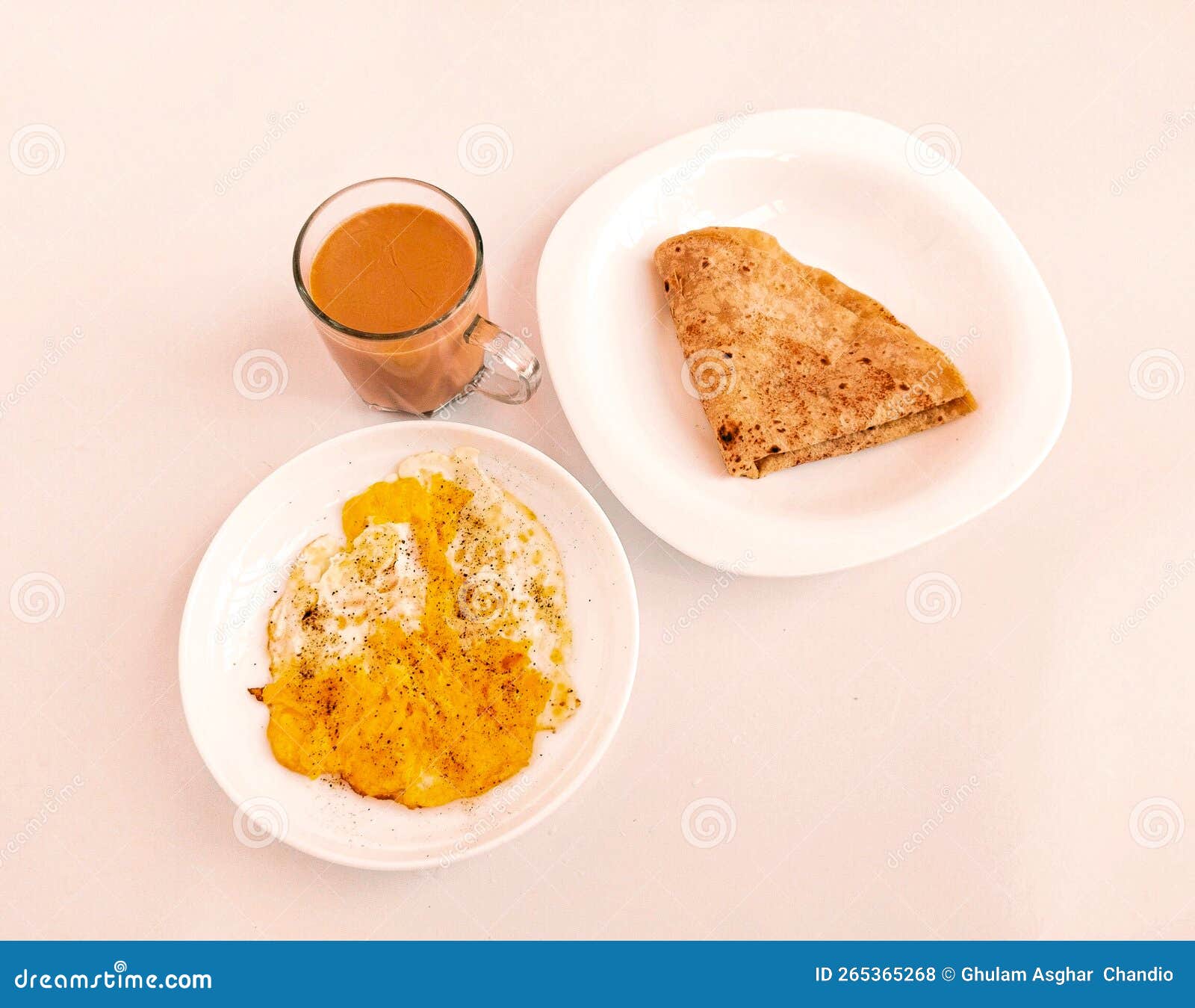 indian  and pakistani home made breakfast cuisine food traditional morning nashta dish fried egg anda paratha and tea photo