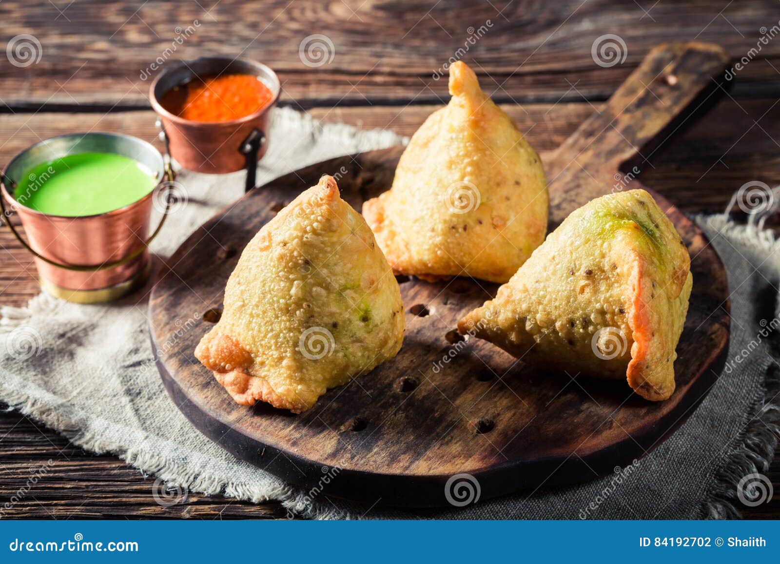 Vegetarian Aloo samosa or samosas. Indian special traditional street food.  Famous Indian Punjabi samosa filled with spicy boiled potato mixture.  served with green and red chutneys. Copy space. Stock Photo