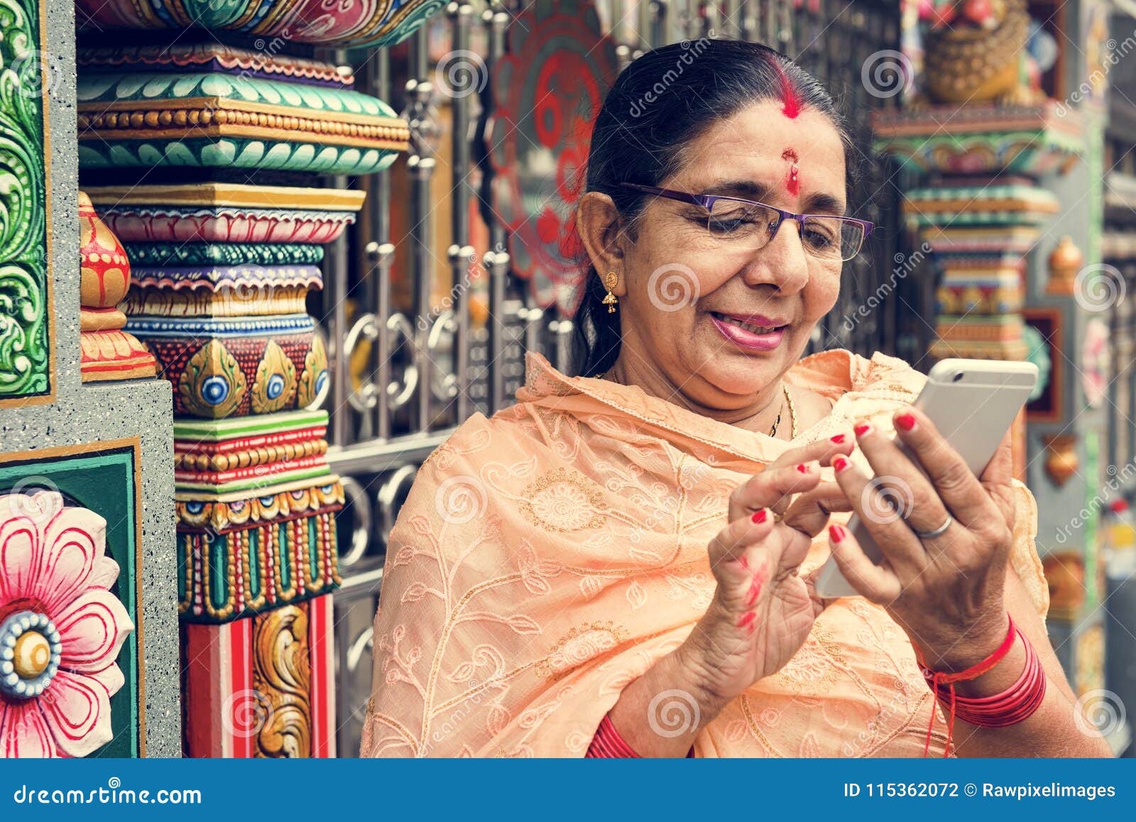 indian senior woman using mobile phone