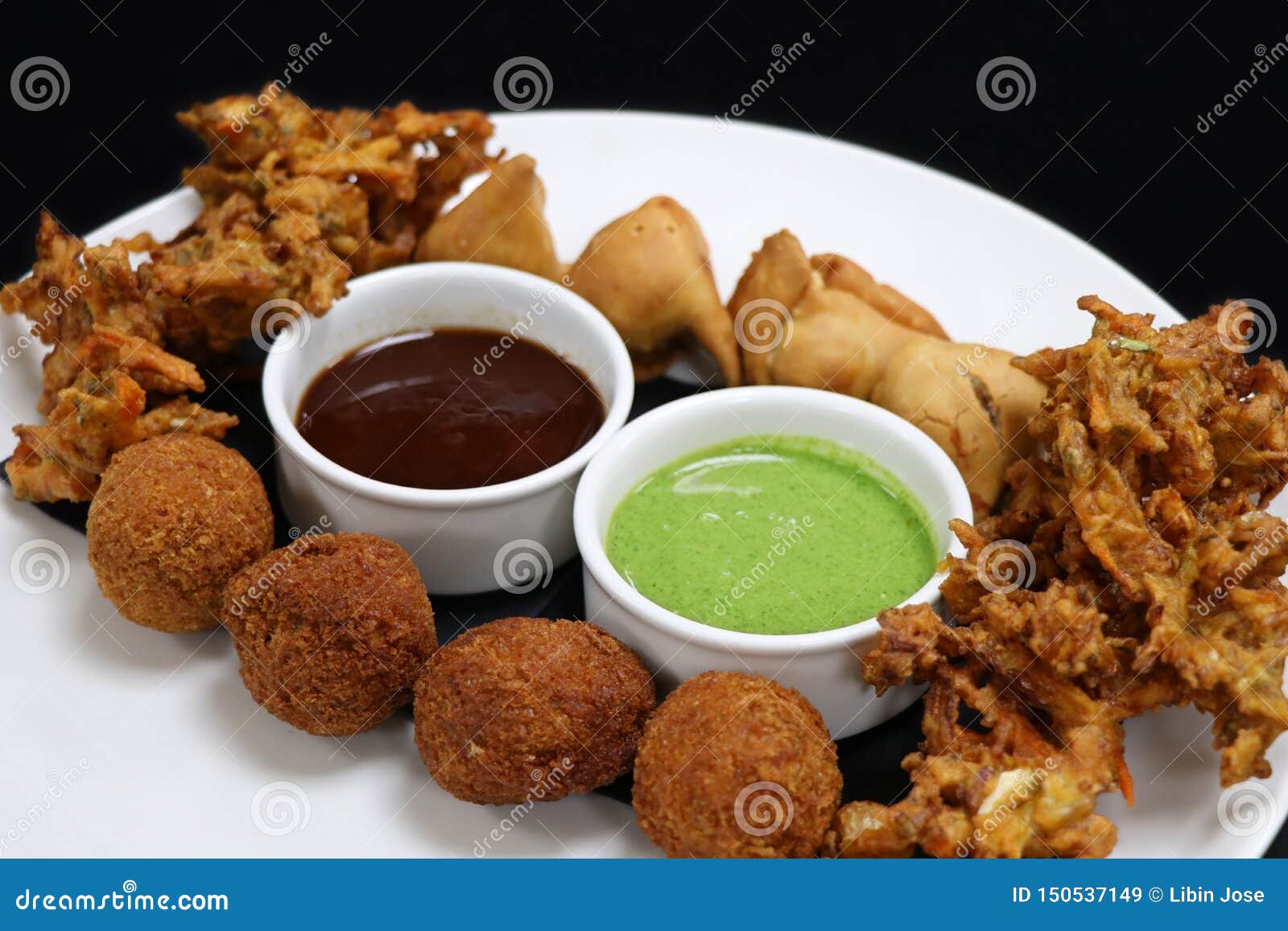 Indian Snack Pakora Platter with Mint and Tamarind Sauce Stock Image