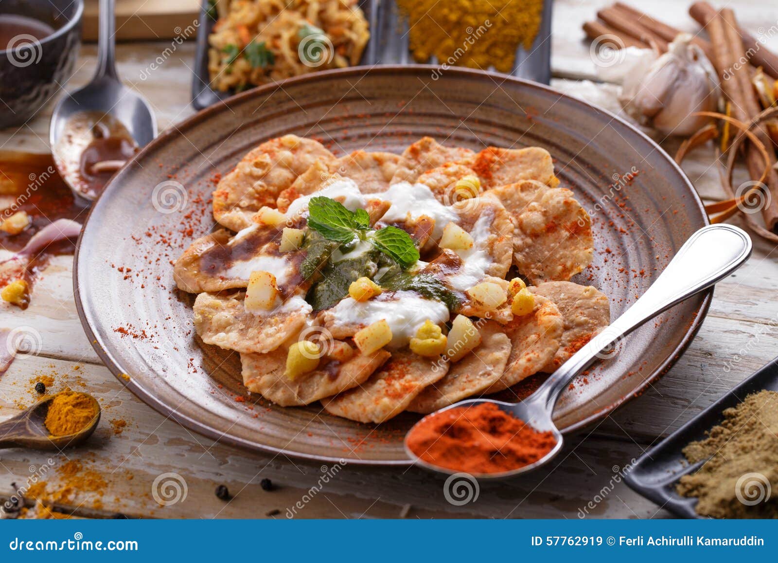 indian streetfood papri chaat garnished and served with yoghurt