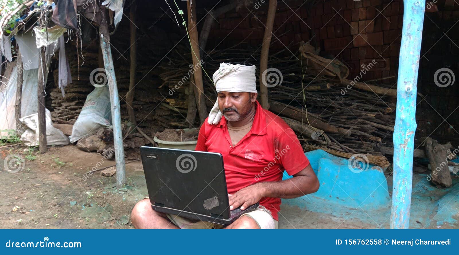 indian-village-farmer-man-working-laptop-computer-system-seating-home-courtyard-matured-woman-corridor-poor-boy-156762558.jpg