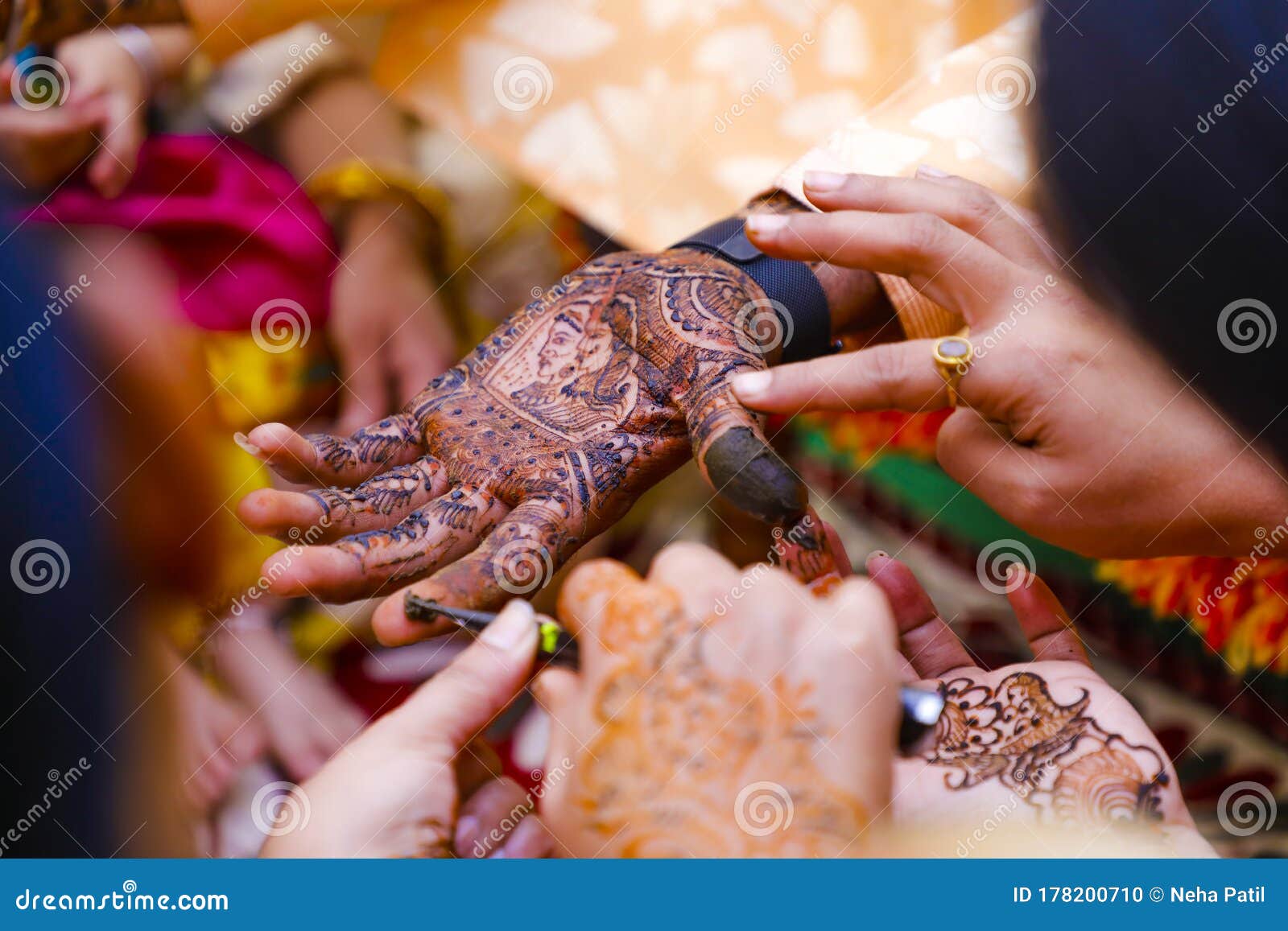 New Delhi, Delhi India- February 28 2021: Ring ceremony and the wedding  function of the Hindu Indian couple holding gold ring with diamond. Royal  bangles covering hands with traditional tattoo- Mehndi Stock