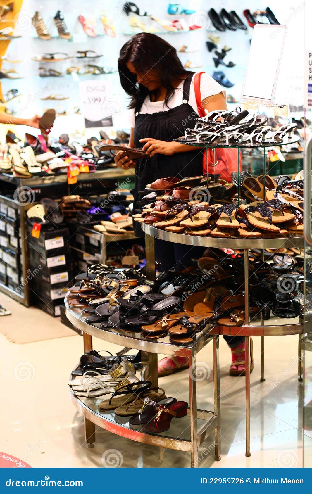 indian woman selecting footwear in a retail outlet