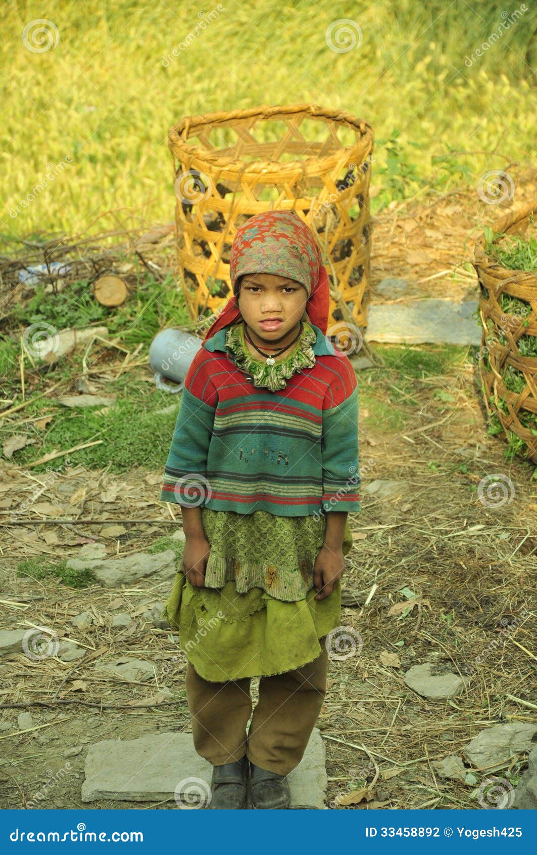 Indian worker girl. A small worker girl in Himalayas region of Uttarakhand state in India gathering woods and food in her basket