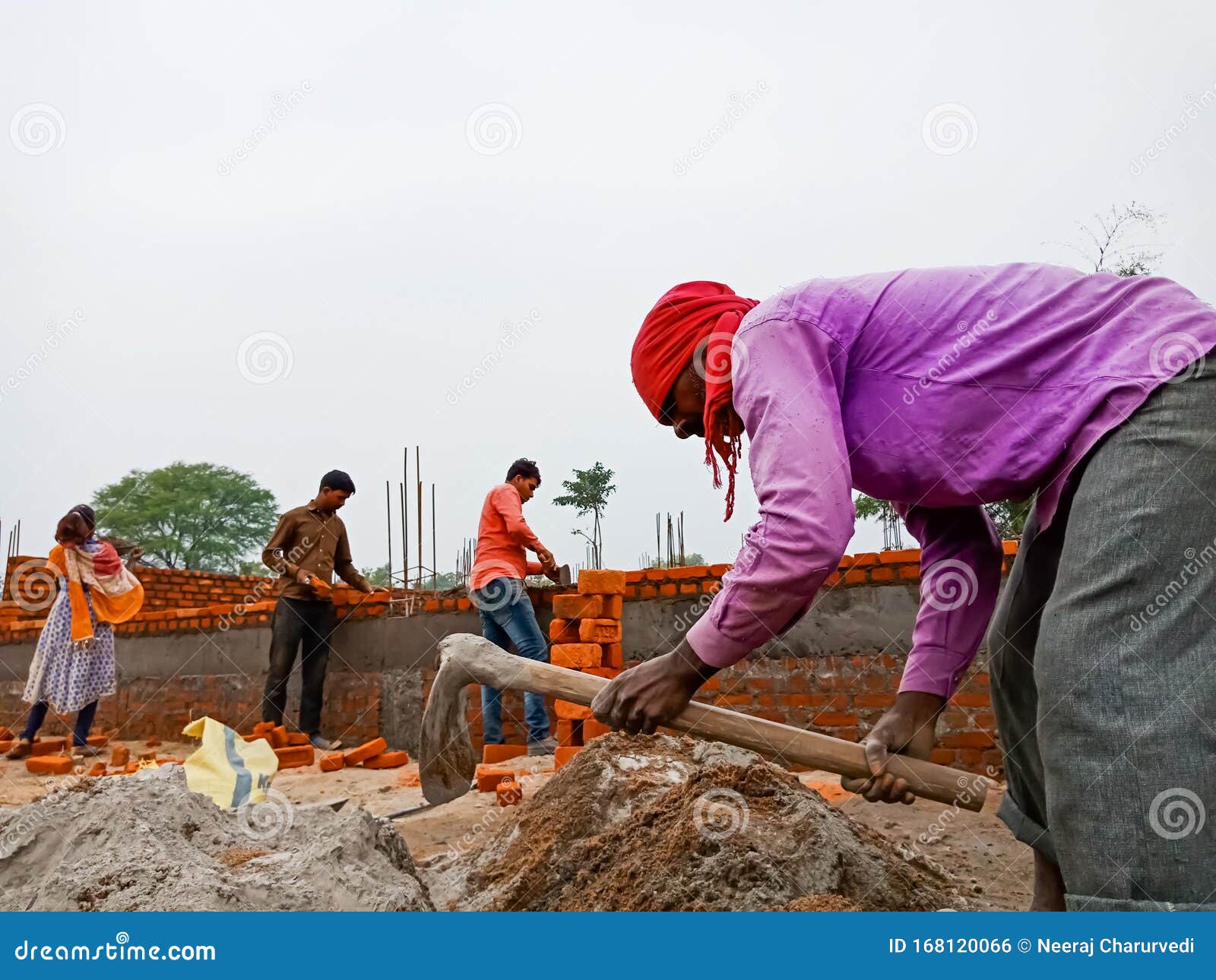 An Indian Worker Holded Spade for Raw Materials Mixing Task at Home