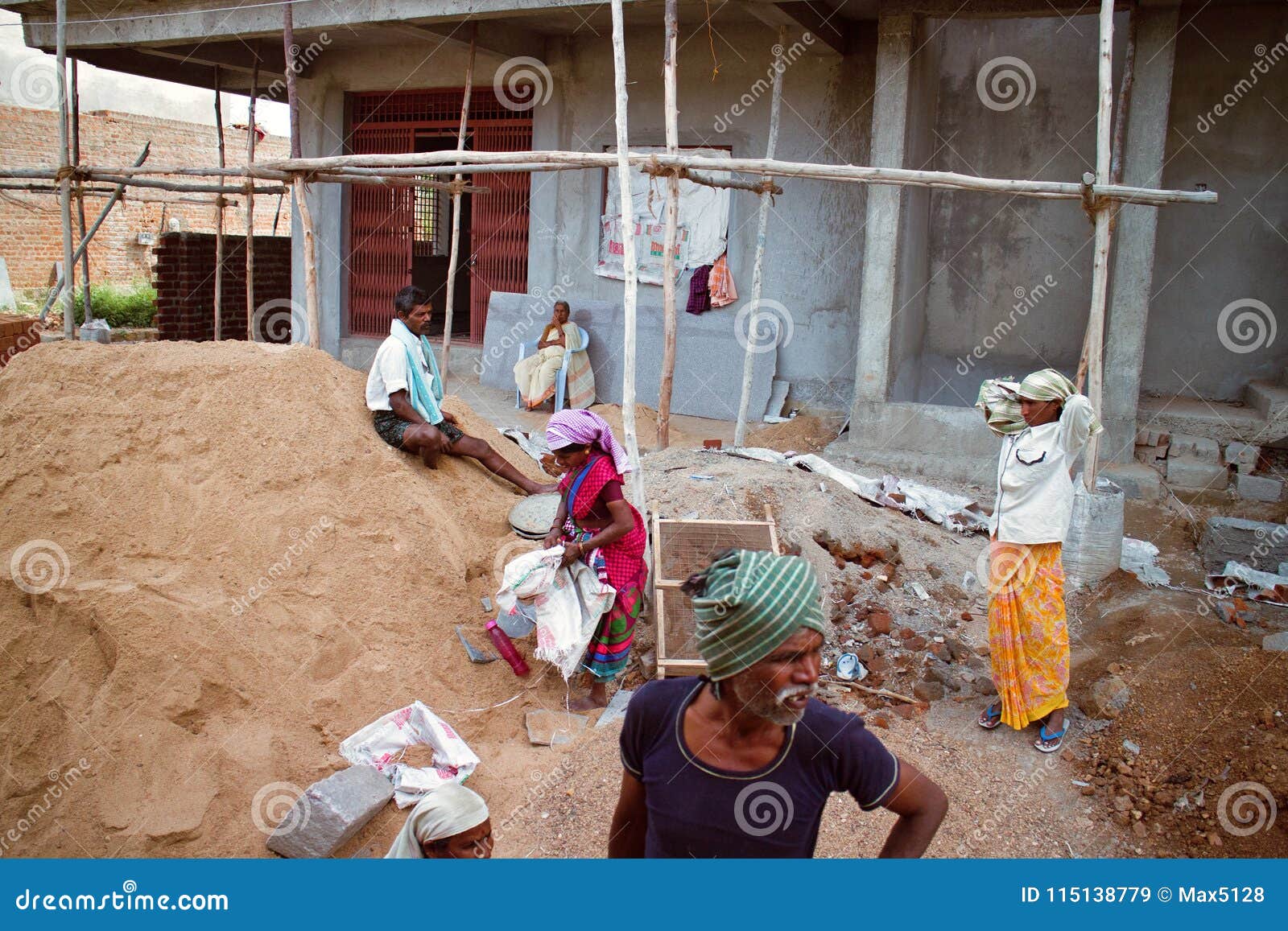 Indian Workers in Construction of Concrete Houses Near Sand Pile