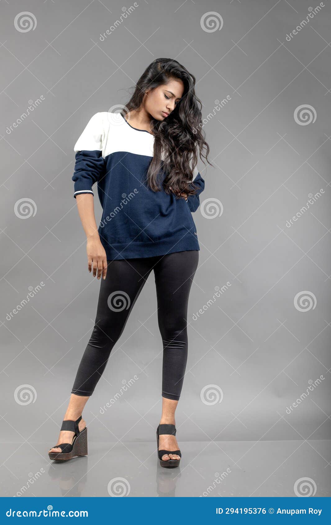 Indian Young Female Model in Casual Winterwear Against Grey Background.  Long Black Haired Model Wearing Black Leggings, Blue and Stock Photo -  Image of casual, jumper: 294195376