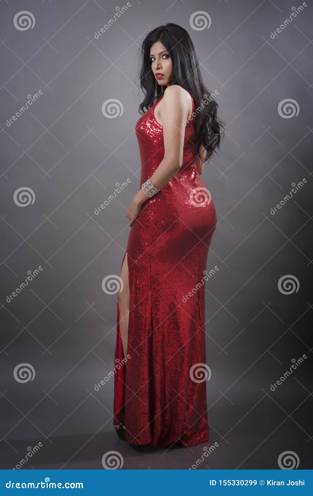 indian young female model in red evening gown stock image