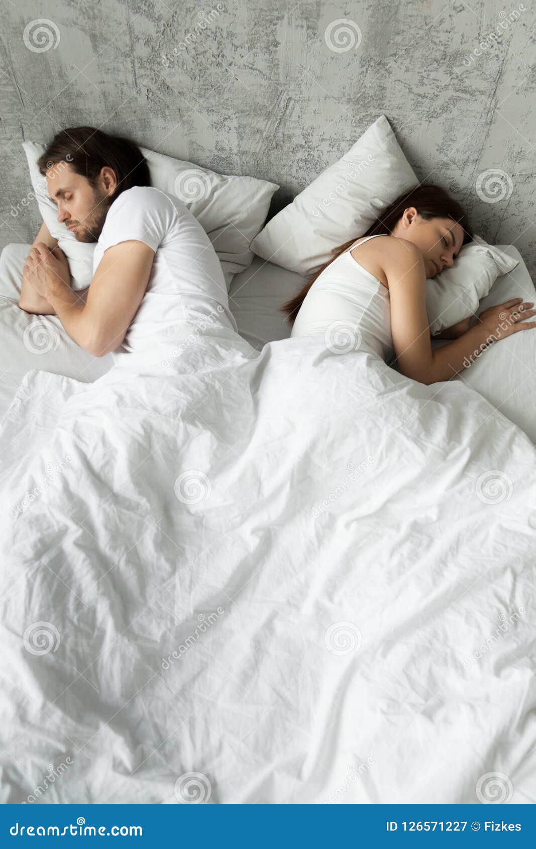 indifferent couple sleep separately avoiding intimacy in bed